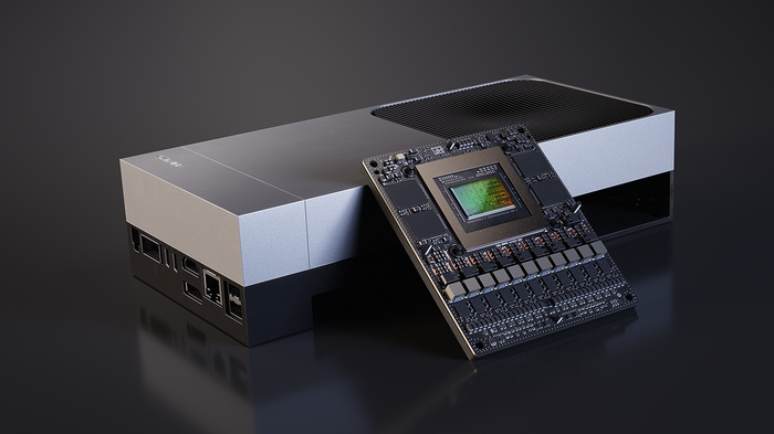 A studio render of an edge compute module — a brushed-metal chassis with a bare accelerator board propped against it, its die exposed at the centre.
